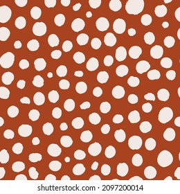 Irregular polka dot seamless repeat pattern on brown background. Random placed, vector african spotted leo like all over print.