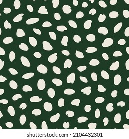 Irregular polka dot seamless repeat pattern on green background. Random placed, vector spots all over surface print.