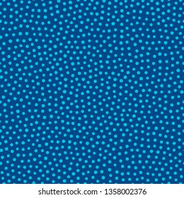 Irregular polka dot seamless vector pattern. Light blue dots on navy blue background. Classic vintage print design. Ditsy scattered textile pattern.