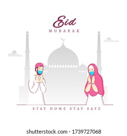 Islamic Festival Eid Mubarak Concept with Muslim Man and Woman wearing mask in front of mosque. Eid celebrations during Covid-19.