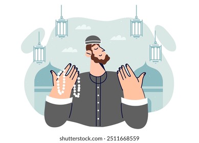 Islamic man praying doing hajj in holy month of ramadan or eid al-fitr, stands near mosques with lanterns. Islamic guy professes islam and reads prayers from karan describing life of allah