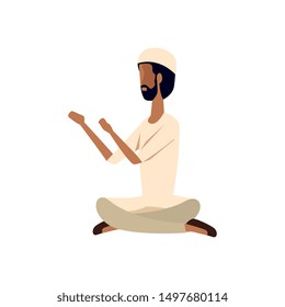 islamic man seated praying with traditional clothes