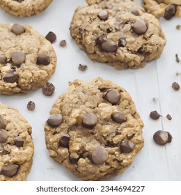 Isolated clipping path of die cut dark chocolate chip cookies piece set stack and crumbs on white background of closeup tasty bakery organic homemade American biscuit sweet dessert.