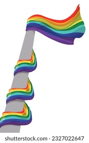 Masa aislada hecha con hormigón y bandera arco iris ondeando, enredada en ella.