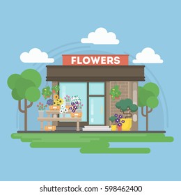Isolated flowers building. Isolated urban building with sign and storefront. City landscape with clouds and trees.