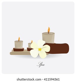 Isolated group of candles and a flower on a white background with text
