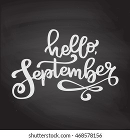 Isolated hand drawn lettering Hello September. White chalk on black chalkboard  background. Vector calligraphy for seasonal advertising.