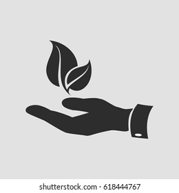 Isolated leaf symbol in hand on a gray background