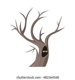 Isolated oak tree without leaves. Two eyes of an animal looking from hollow