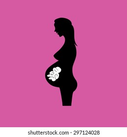 Isolated pregnant woman silhouette icon in pink background. Unborn baby sleeping and smiling in the placenta.