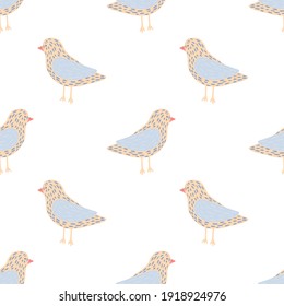 Isolated seamless pattern with hand drawn blue and beige colored dove birs ornament. Vector illustration for seasonal textile prints, fabric, banners, backdrops and wallpapers.