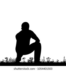  isolated silhouette man sitting on the grass