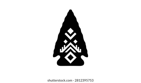 An isolated silhouette of a stone arrowhead featuring carved geometric tribal patterns in white on a black background