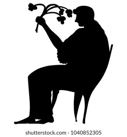 Isolated vector silhouette of an ancient Greek woman or goddess on a throne holding a bouquet of flowers or a branch of plant. 