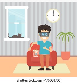 Isolated vr man. Young smiling man using vr glasses sits on armchair with popcorn on white background. Home entertainment. Augmented reality, new technologies. 3D film.