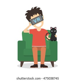 Isolated vr man. Young smiling man using vr glasses sits on armchair with black cat. Home entertainment. Augmented reality, new technologies. Video game or 3D film.