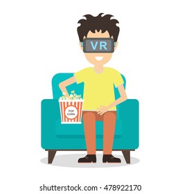 Isolated vr man. Young smiling man using vr glasses sits on armchair with popcorn on white background. Home entertainment. Augmented reality, new technologies. 3D film.