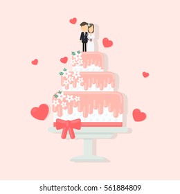 Isolated wedding cake with decoration as figures of wife and husband, ribbons and flowers.