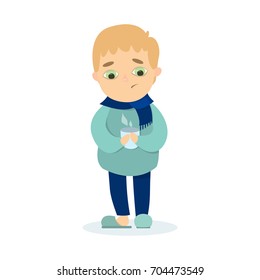 Isolted sick boy standing with scarf and hot drink in mug on white background.