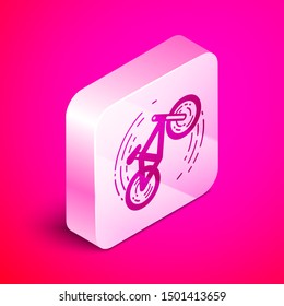 Isometric Bicycle trick icon isolated on pink background. Bike race. Extreme sport. Sport equipment. Silver square button. Vector Illustration