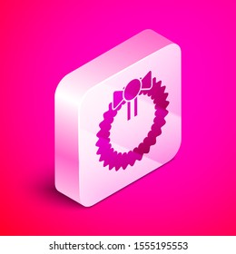 Isometric Christmas wreath icon isolated on pink background. Merry Christmas and Happy New Year. Silver square button. Vector Illustration