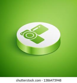 Isometric Cinema camera icon isolated on green background. Video camera. Movie sign. Film projector. White circle button. Vector Illustration