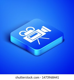 Isometric Cinema camera icon isolated on blue background. Video camera. Movie sign. Film projector. Blue square button. Vector Illustration