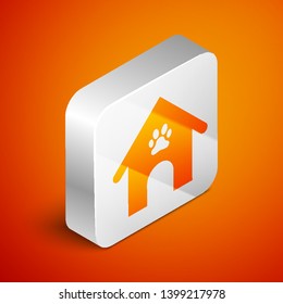 Isometric Dog house and paw print pet icon isolated on orange background. Dog kennel. Silver square button. Vector Illustration