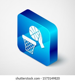 Isometric Hand with basketball ball and basket icon isolated on white background. Ball in basketball hoop. Blue square button. Vector Illustration