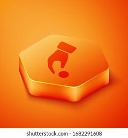 Isometric Hand holding casino chips icon isolated on orange background. Casino gambling. Orange hexagon button. Vector Illustration
