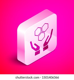 Isometric Honeycomb and hands icon isolated on pink background. Honey cells symbol. Sweet natural food. Silver square button. Vector Illustration