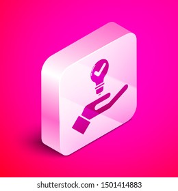 Isometric Light bulb in hand icon isolated on pink background. Concept of idea. Silver square button. Vector Illustration