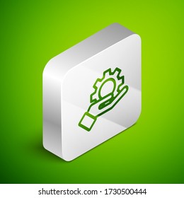 Isometric line Hand settings gear icon isolated on green background. Adjusting, service, maintenance, repair, fixing. Silver square button. Vector Illustration