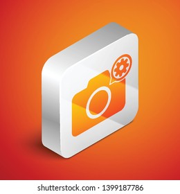 Isometric Photo camera and gear icon isolated on orange background. Adjusting app, service concept, setting options, maintenance, repair, fixing. Silver square button. Vector Illustration