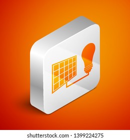 Isometric Solar energy panel and light bulb icon isolated on orange background. Silver square button. Vector Illustration