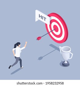 isometric vector illustration on gray background, woman happily runs up to the target with an arrow in the center and the winner's cup, hit the target