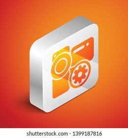 Isometric Video camera and gear icon isolated on orange background. Adjusting app, service concept, setting options, maintenance, repair, fixing. Silver square button. Vector Illustration