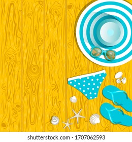 items,of summer wardrobe and shells on wooden boards