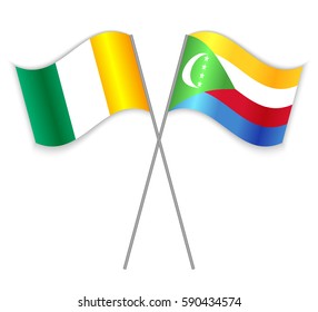Ivorian and Comoran crossed flags. Ivory Coast combined with Comoros isolated on white. Language learning, international business or travel concept.