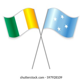 Ivorian and Micronesian crossed flags. Ivory Coast combined with Micronesia isolated on white. Language learning, international business or travel concept.