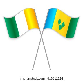 Ivorian and Vincentian crossed flags. Ivory Coast combined with Saint Vincent and the Grenadines isolated on white. Language learning, international business or travel concept.