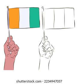 The Ivory Coast flag is in the hand of a man in color and black and white. The concept of patriotism.