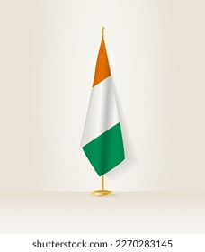 Ivory Coast flag on a flag stand. Vector illustration.