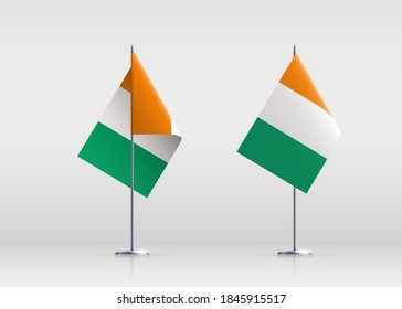 Ivory Coast flag state symbol isolated on background national banner. Greeting card National Independence Day of the Republic of Côte d'Ivoire. Illustration banner with realistic state flag.