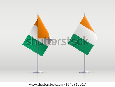 Ivory Coast flag state symbol isolated on background national banner. Greeting card National Independence Day of the Republic of Côte d'Ivoire. Illustration banner with realistic state flag.
