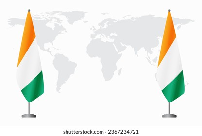 Ivory Coast and Ivory Coast flags for official meeting against background of world map.