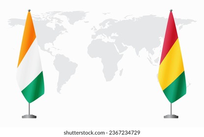 Ivory Coast and Guinea flags for official meeting against background of world map.