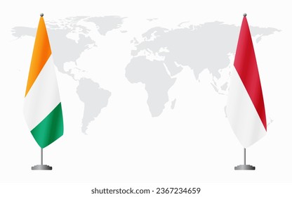 Ivory Coast and Monaco flags for official meeting against background of world map.