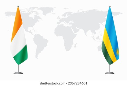 Ivory Coast and Rwanda flags for official meeting against background of world map.