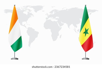 Ivory Coast and Senegal flags for official meeting against background of world map.